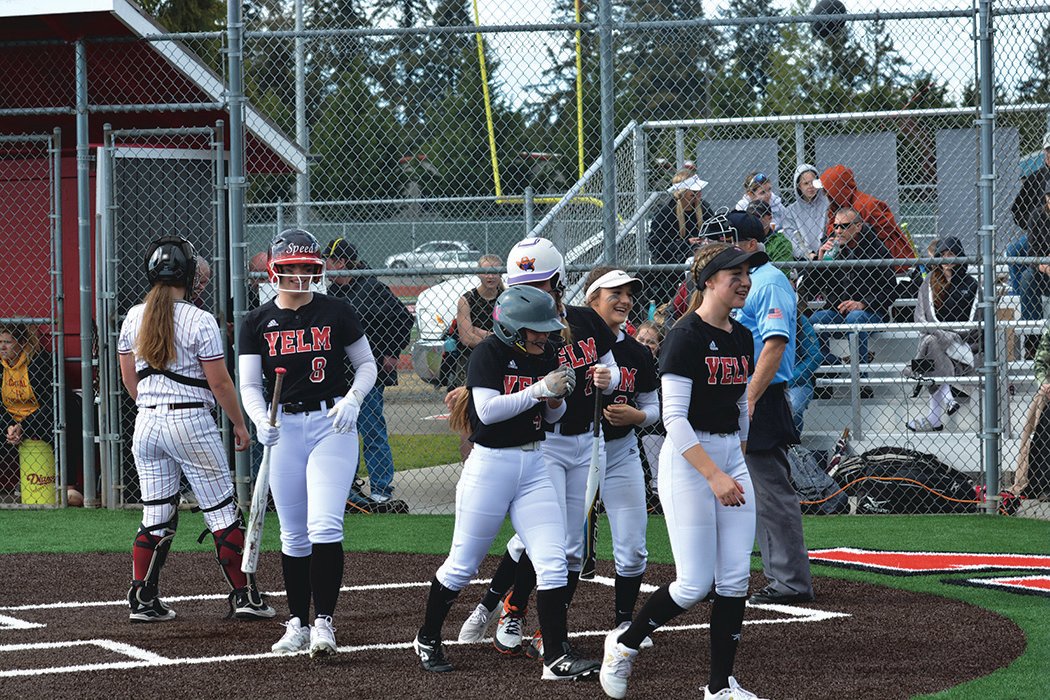 The Tornados dug-out empties to embrace sophomore outfielder Elissa Dewees (4) after her inside the park homerun on May 9 during a game against Capital High School.