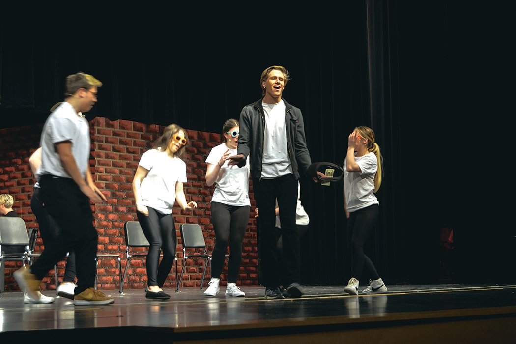Connor McCormick, flanked by A.J. Hicks, Maiya Mohrweis, Jaden Lawrence-Olsen and Charlease Hyder, takes the lead during a song in the Yelm Drama Club's performance of "Working."