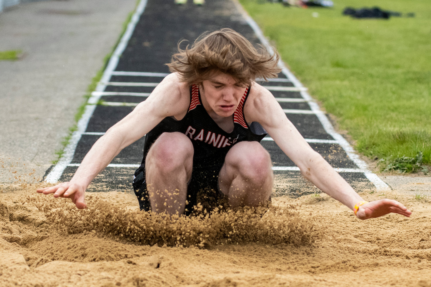 Rainier's Chase MacFarland hits the triple jump pit during the Central 2B League Championships on May 13.