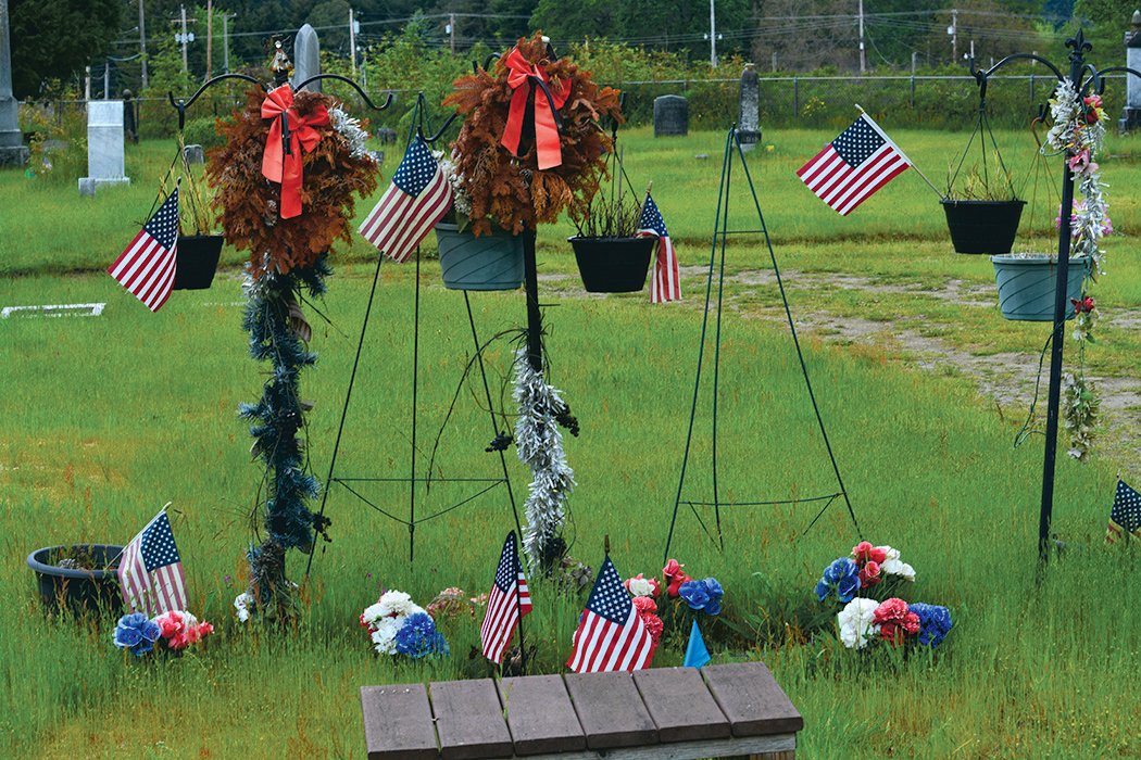 Flags were placed at the gravesites in Roy to honor the lives of those who died in combat.