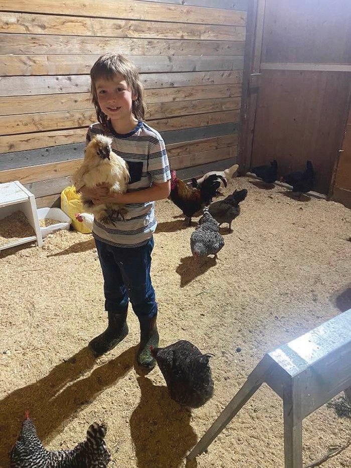 Theo helps raise chickens and sells their eggs on his family’s property in Yelm.