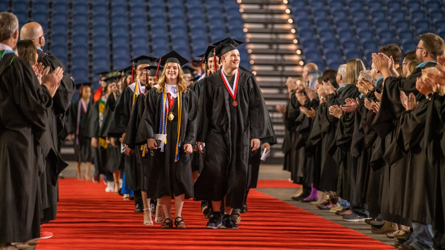 Students walk through the Tacoma Dome during their graduation ceremony on June 16.