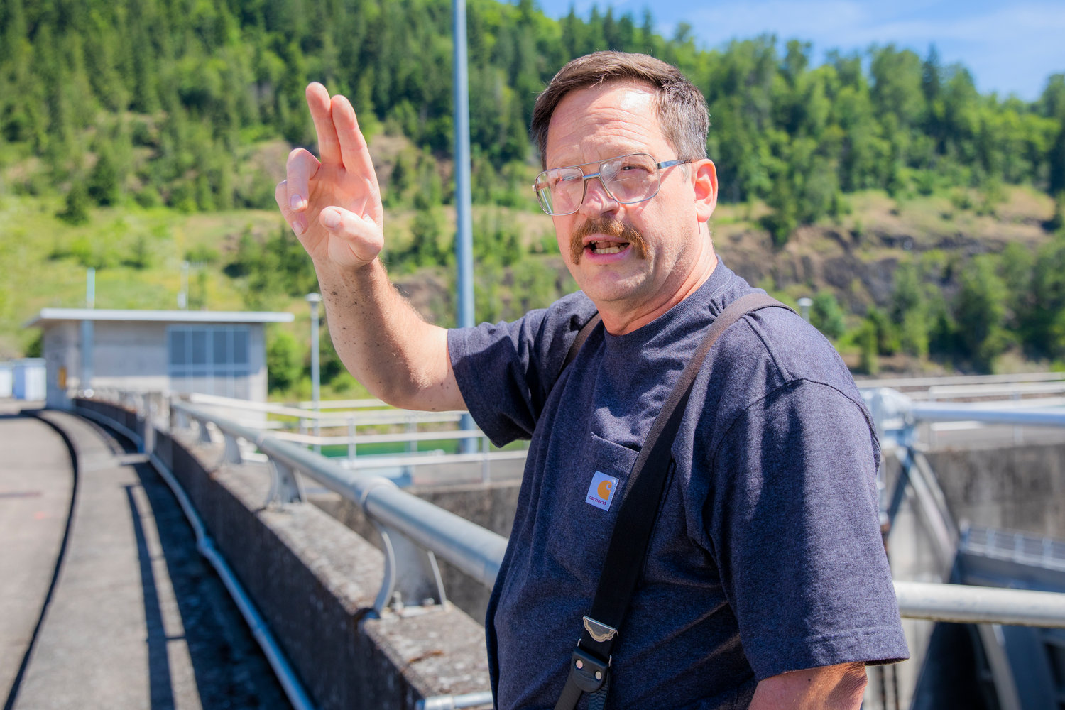 Journeyman Clarence Lupo talks about electricity flowing through cables around the dam near the Tacoma City Light powerhouse in Mossyrock.