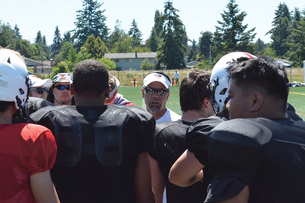 Yelm’s head football coach Jason Ronquillo addresses the team after they scrimmaged against Lincoln High School of Tacoma.
