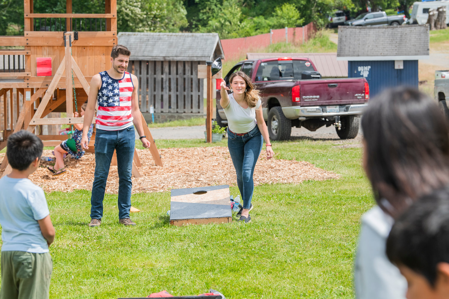 Shane and Lauren Welter smile while playing cornhole at the Lions Den Campground before performing music together as “Shore Lane,” Saturday in Mineral.