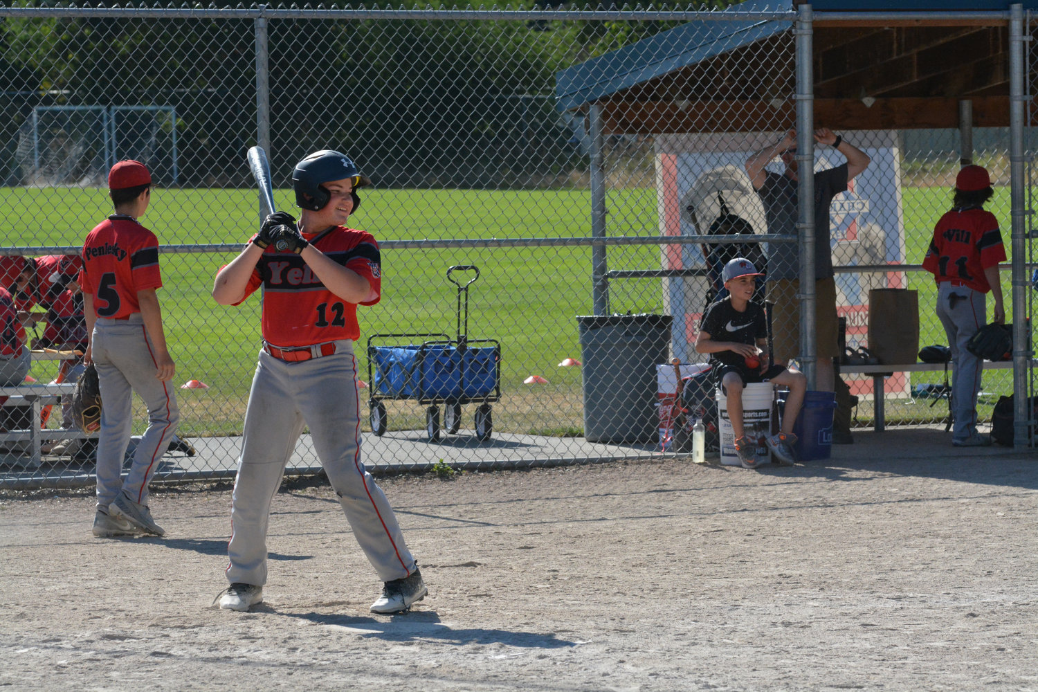 Nisqually Basin 12U All Star Finn Hanly smiles as he awaits the pitch in the batter's box.