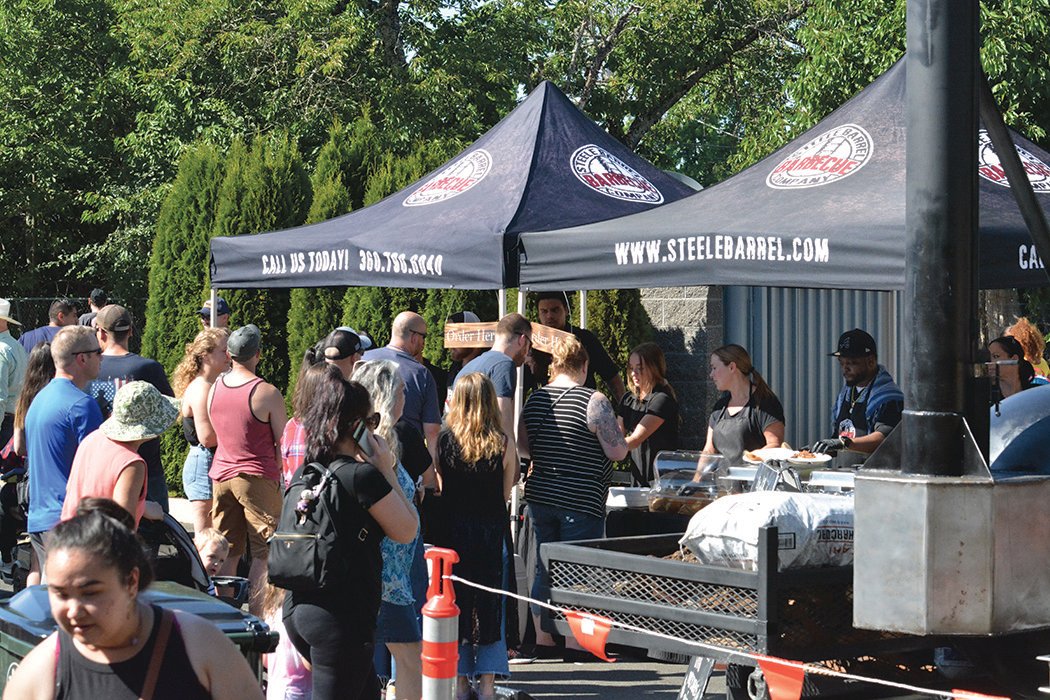 People line up at the Steele Barrel Barbecue tent, which took home the People’s Choice award, at the Nisqually Valley Barbecue Rally on July 23.