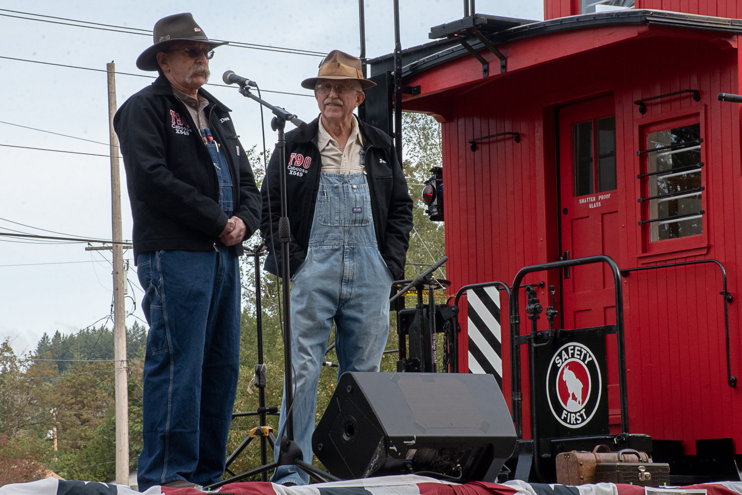 Don Bowman, left, and Jan Wigley, right, talk a crowd of around 100 people about restoration work they did over the past two years on the caboose for the Tenino Depot Museum.