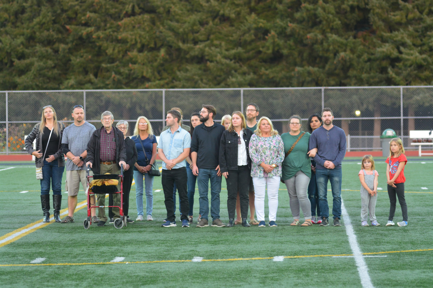 The Kain family stands near midfield prior to the celebration of life for Mike Kain on Sept. 29.