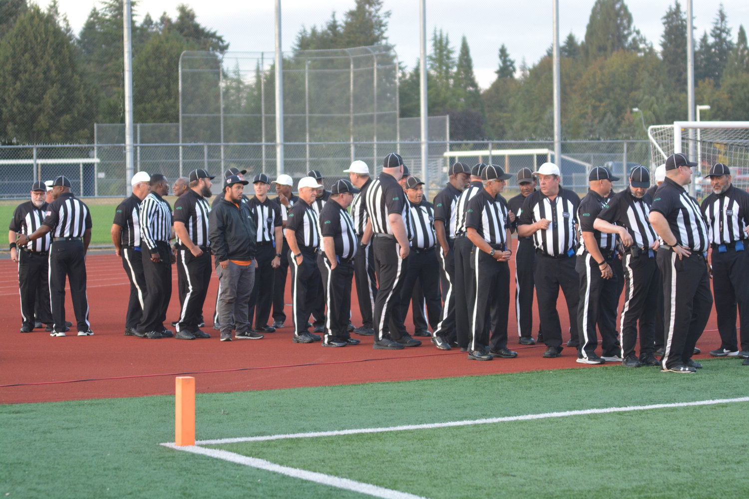 Referees gather prior to the celebration of life for Mike Kain on Sept. 29.