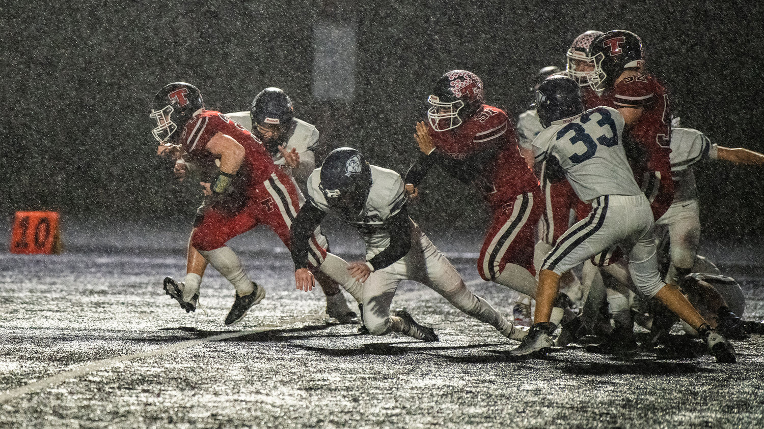 Tenino senior Randall Marti (34) blows past defenders with the football during a Friday night game at Beaver Stadium.