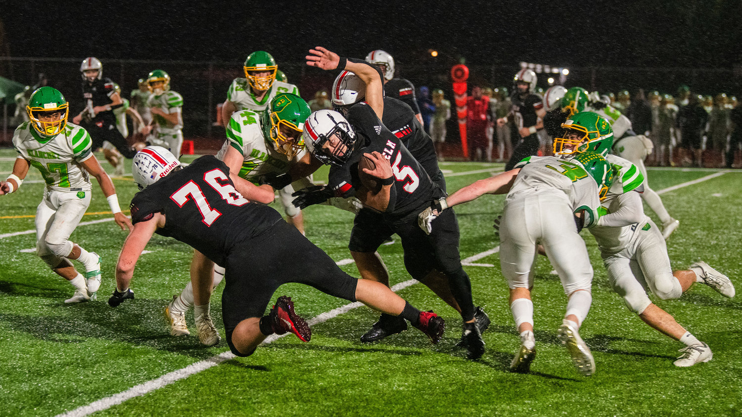 Yelm senior Kyler Ronquillo (5) runs with the football during a game against the Bishop Blanchet Bears on Friday, Nov. 4.