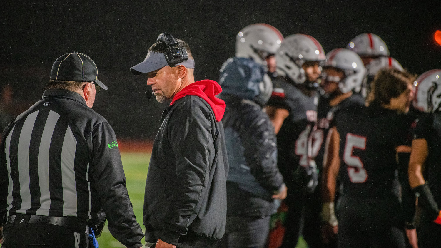 Yelm Head Coach Jason Ronquillo talks to a referee after a play during the Friday night game against Bishop Blanchet.