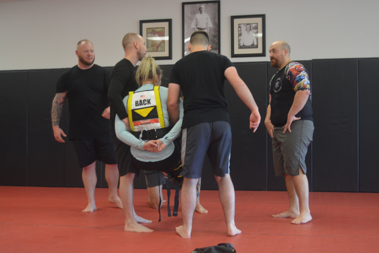 Members of the Yelm Police Department demonstrate a technique used to detain people during a training session at Harai Dojo.