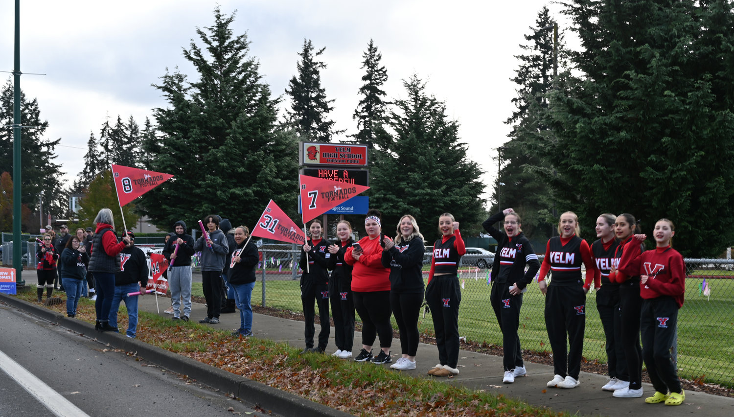 Yelm High School cheerleaders and other supporters gather outside of Yelm High School on Saturday, Nov. 26 to send the football team off to their semifinal game.
