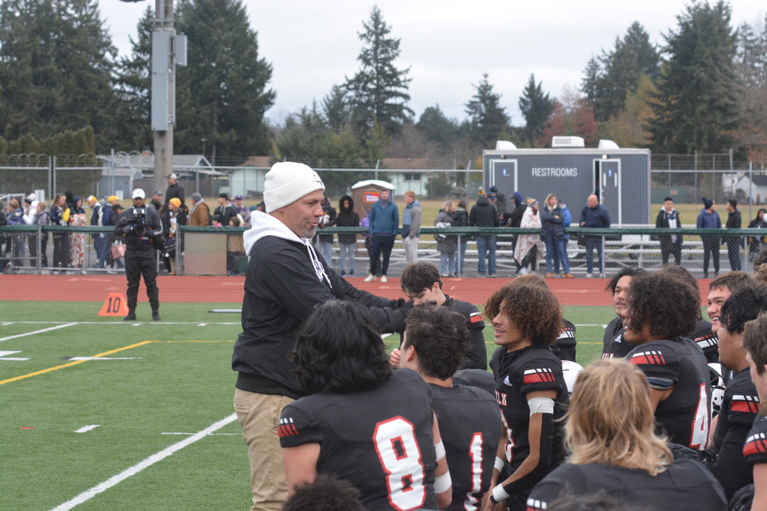 Jason Ronquillo smiles as he addresses his team after Yelm’s win against Bellevue on Nov. 26.