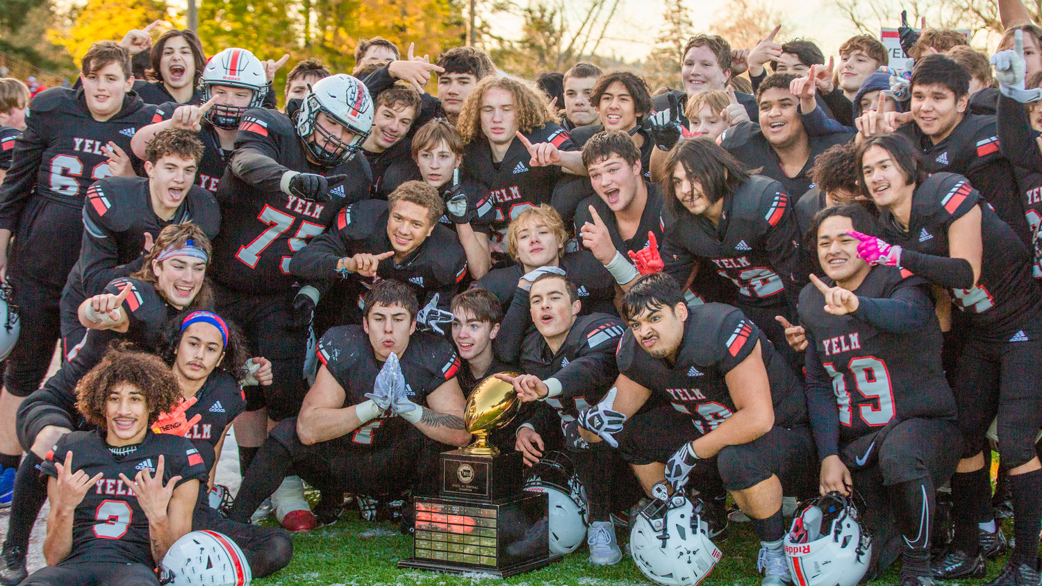 The Yelm football team poses with the 3A state trophy after its 20-13 win over Eastside Catholic in Puyallup on Dec. 3.