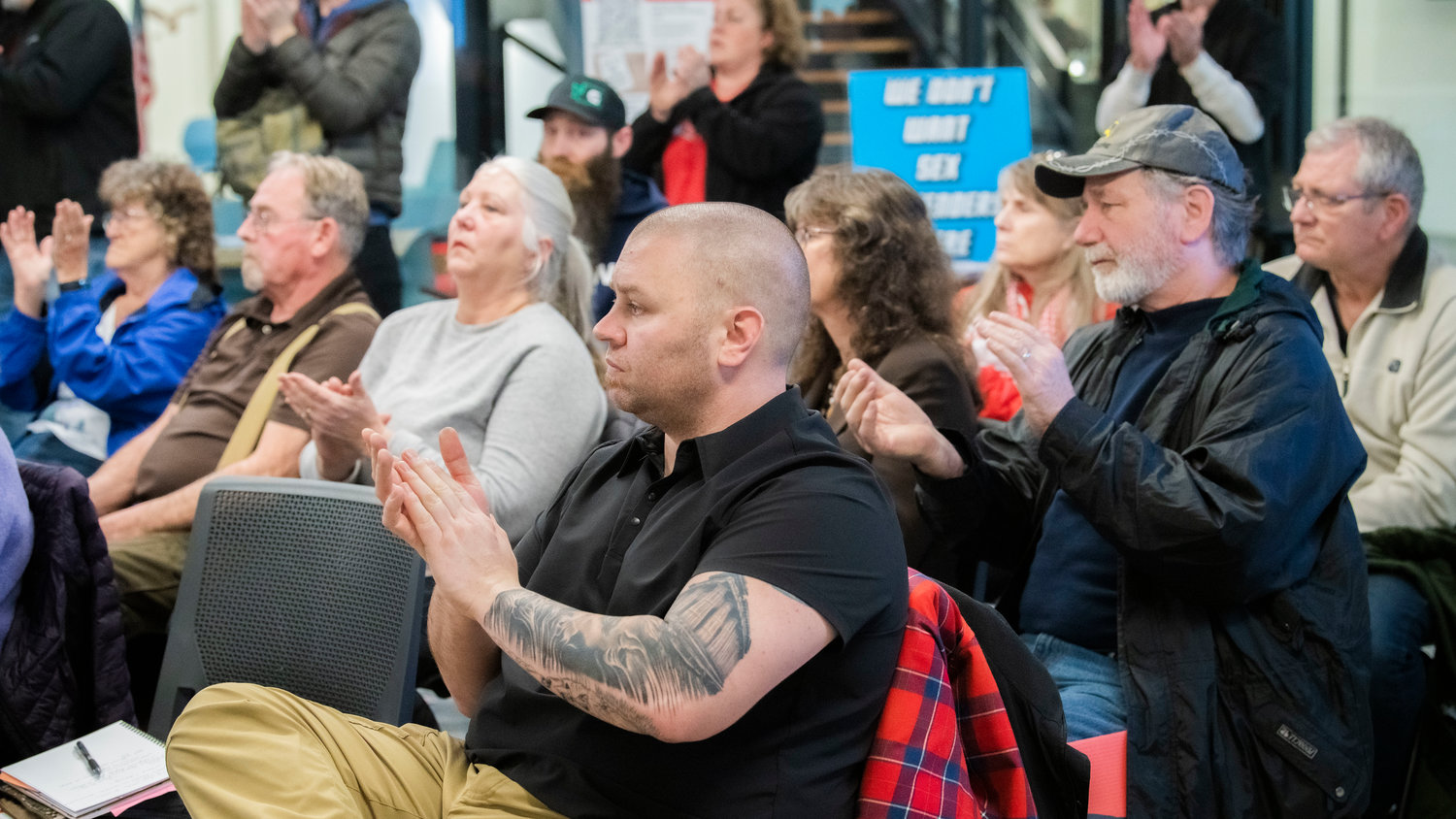 Tenino Mayor Wayne Fournier attends a meeting with Thurston County Commissioners in Olympia on Tuesday while clapping for residents speaking in opposition of a Supreme Living facility located at 2813 140th Avenue Southwest in Tenino.