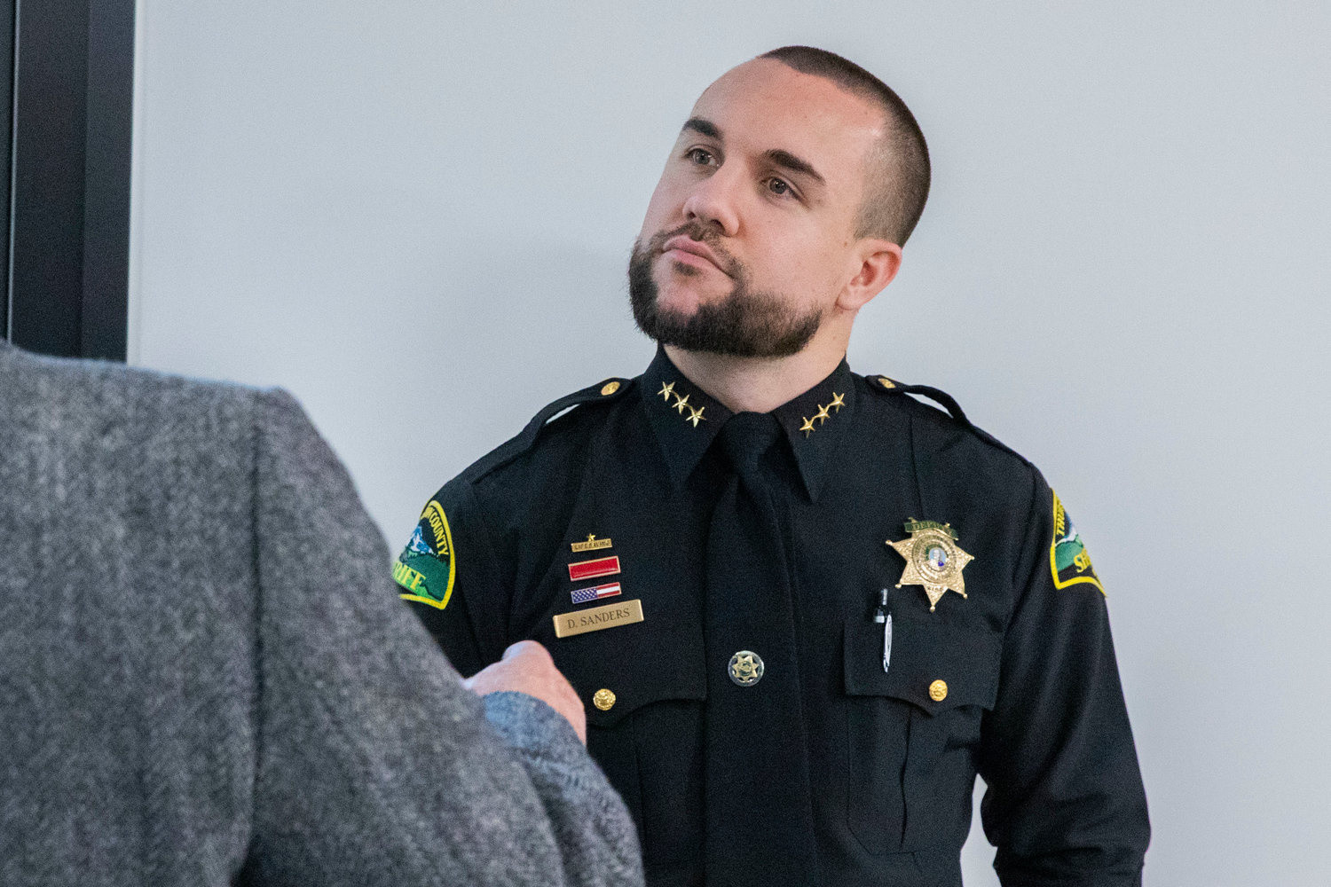 Thurston County Sheriff Derek Sanders attends a meeting where Tenino residents came to speak out against a Supreme Living facility on property in Tenino.