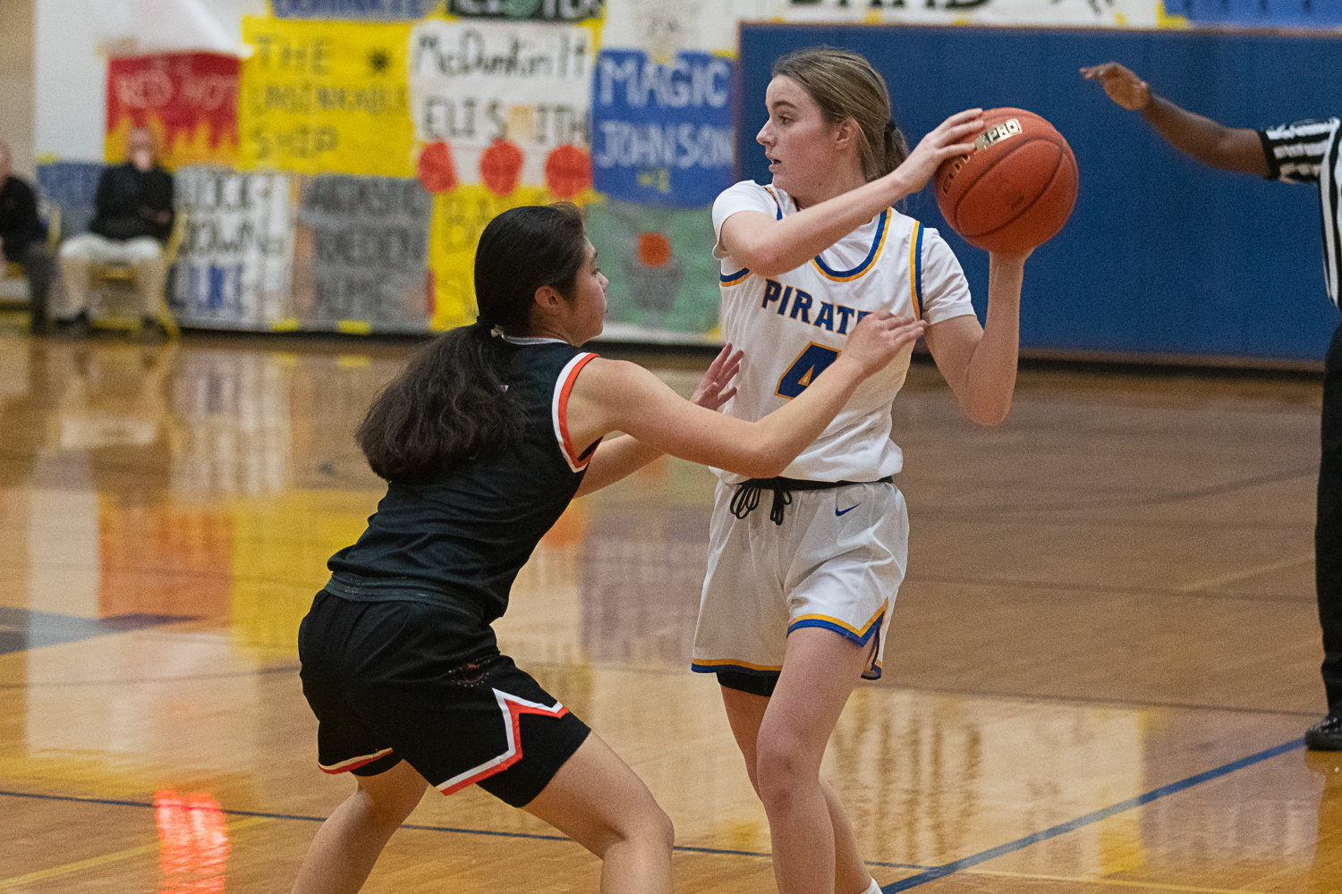Adna's Brooklyn Loose keeps the ball away from Rainier's Angelica Askey during the first half of the Pirates' 51-47 win over the Mountaineers at home on Jan. 19.