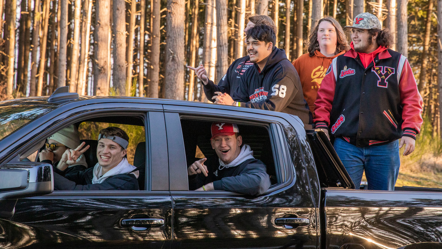 Tornado coaches and athletes smile and look on from a truck during a celebration parade in Yelm Monday evening.