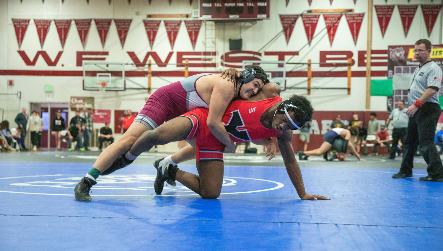 W.F. West’s Angelo Peters wrestles Genesis Finch from Yelm during the Bearcat Invitational on Saturday in Chehalis.