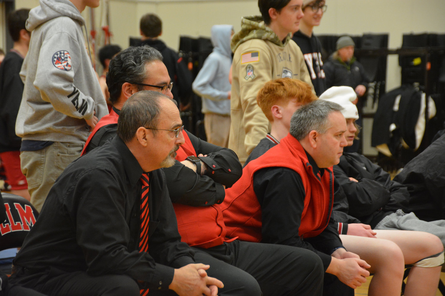 Yelm wrestling coaches watch on as the junior varsity competes on retro night on Jan. 26.