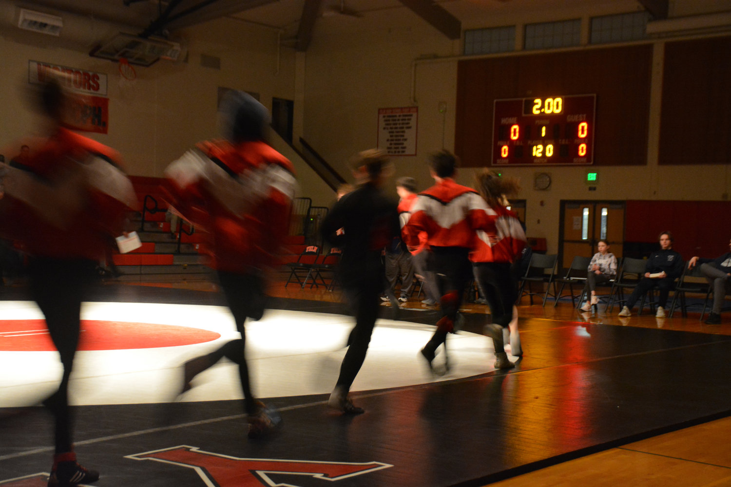 The Yelm boys wrestling team storms the mat as part of their warm up on Jan. 26.