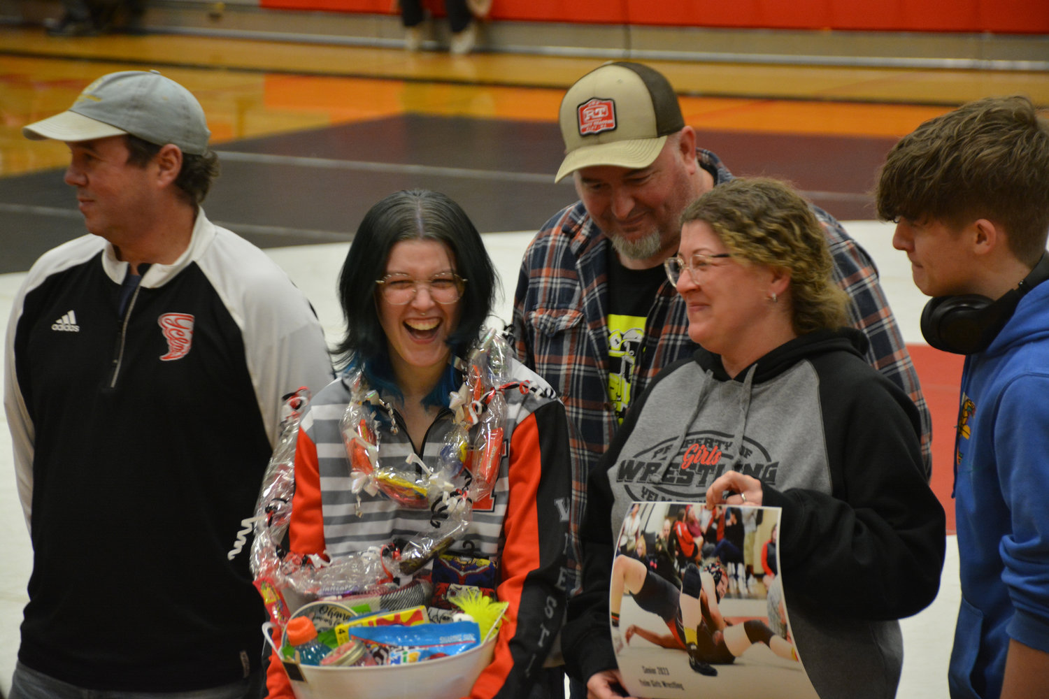 A Yelm wrestling senior excitedly accepts a gift basket on senior night on Thursday, Jan. 26.