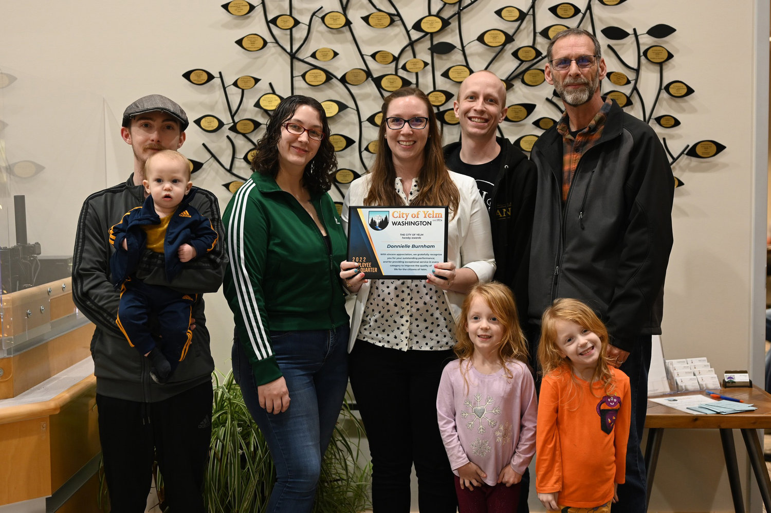 Donni Burnham poses with her family after she was named Yelm’s Employee of the Quarter.