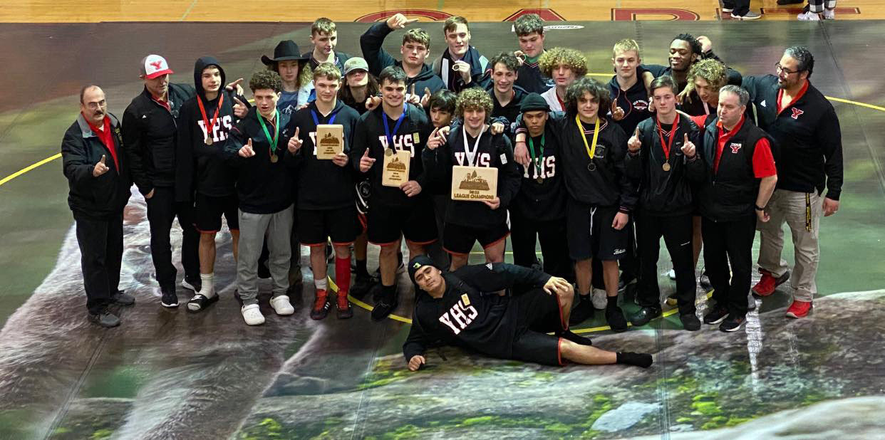 The Yelm boys wrestling team poses for a photo following their first place finish at the district tournament.