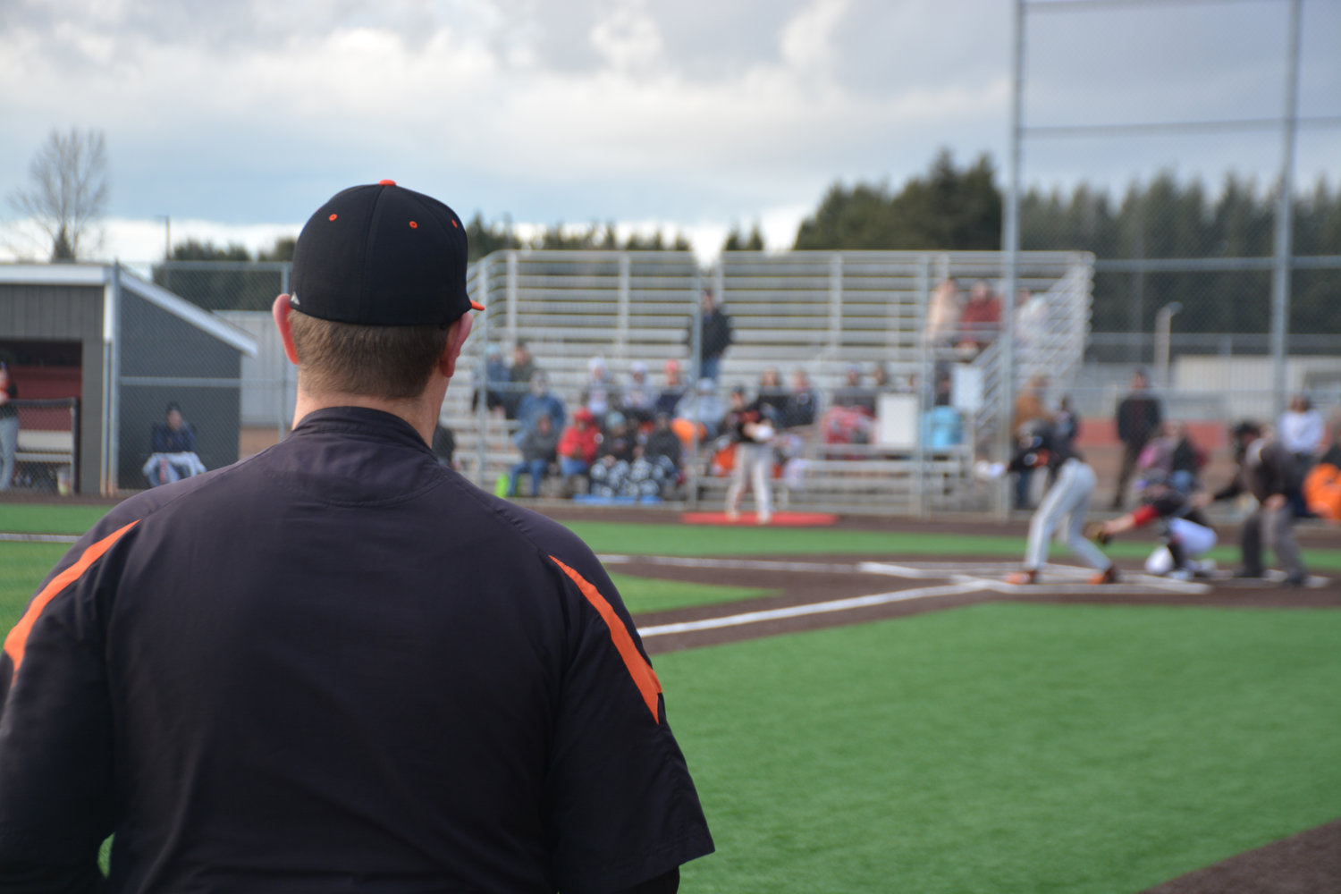 Rainier Head Coach Mark Mounts watches his team during a game against Yelm on Friday, March 10.