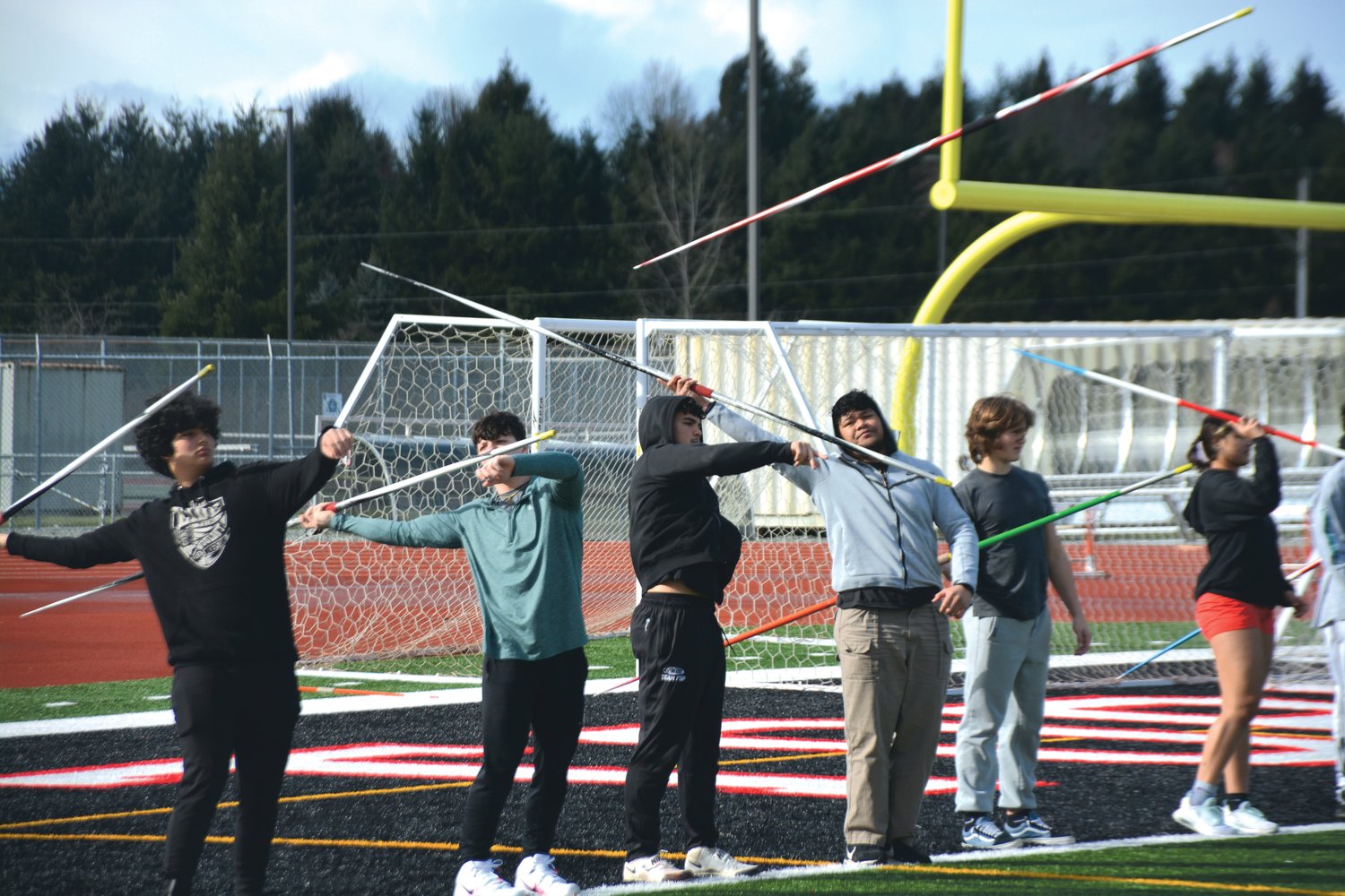 Yelm javelin throwers participate in a warm-up exercise at practice on Friday, March 10.