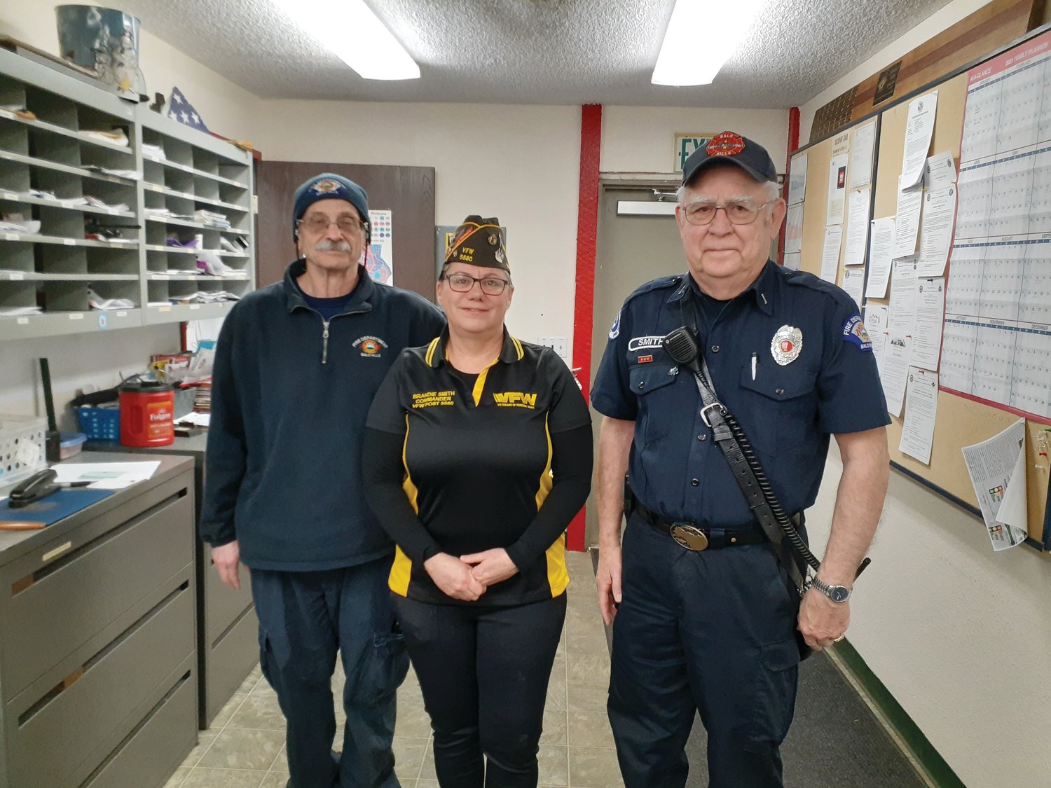 Bald Hills Fire District volunteers Mark Edwards and Ron Smith pose for a photo with Brandi Smith, the commander of VFW Post 5580, after they received their awards.