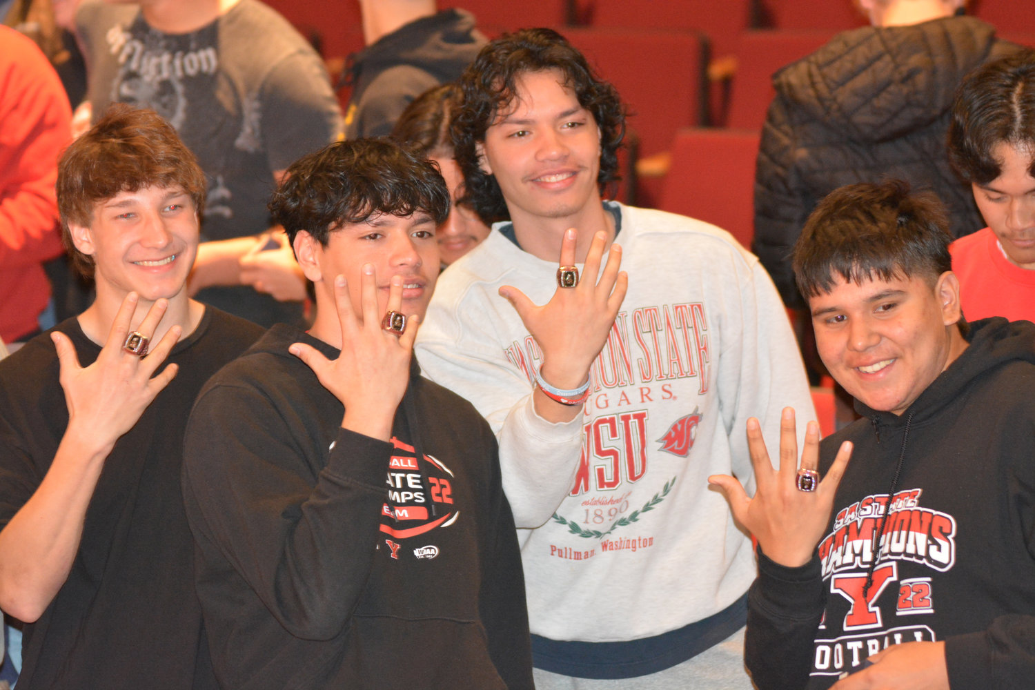 Jordan Lasher, Marius Aalona, Damian Aalona and Ace Youckton show off their new championship rings at Yelm High School on Monday, March 27.