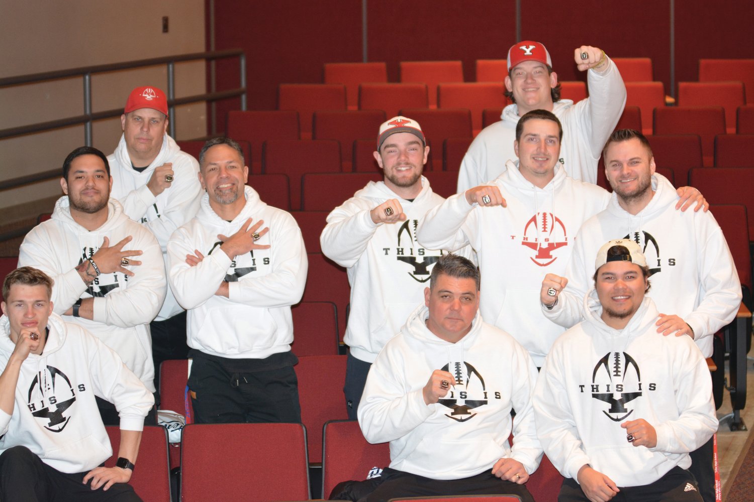 Coaches of the Yelm football program pose with their championship rings on Monday, March 27 at Yelm High School.