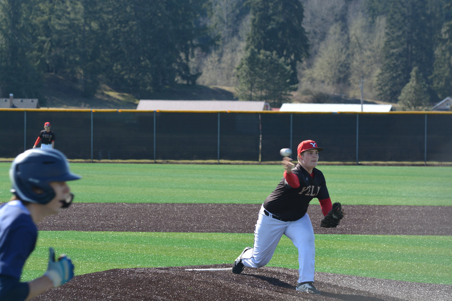 Freshman Jonah Smith delivers a strike against Gig Harbor at home on Tuesday, March 21.