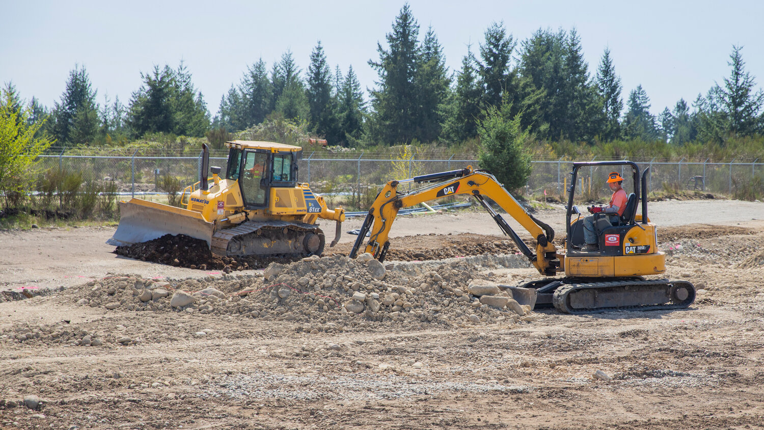 Crews use equipment to turn dirt during construction of an agricultural park along Old Highway 99 SE in Tenino on Thursday, April 27, 2023.