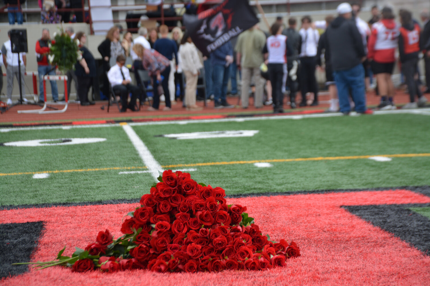 Roses lay on the field at Yelm High School’s stadium in memory of Shawn Jemtegaard on May 21.