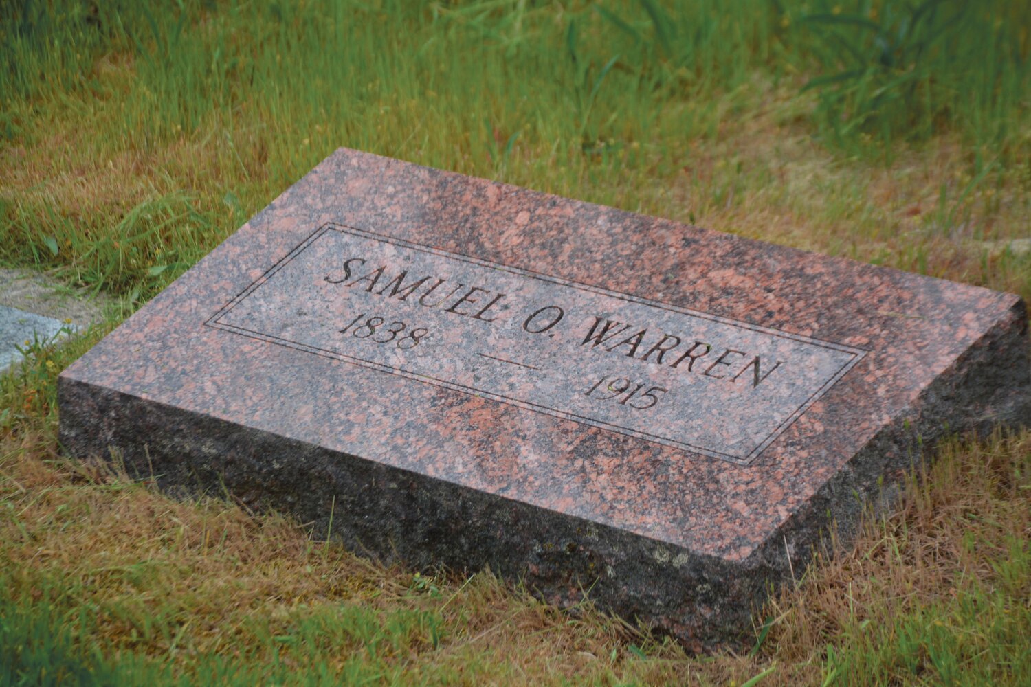 A gravestone for Samuel Warren, who is considered a founding father of Roy, sits at the Roy Cemetery.