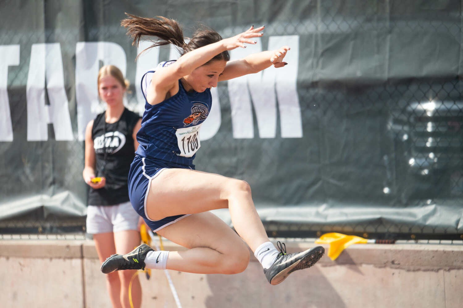 Pe Ell's Charlie Carper goes airborne during the long jump finals at the 1B state championships at Zaepfel Stadium in Yakima on May 25.