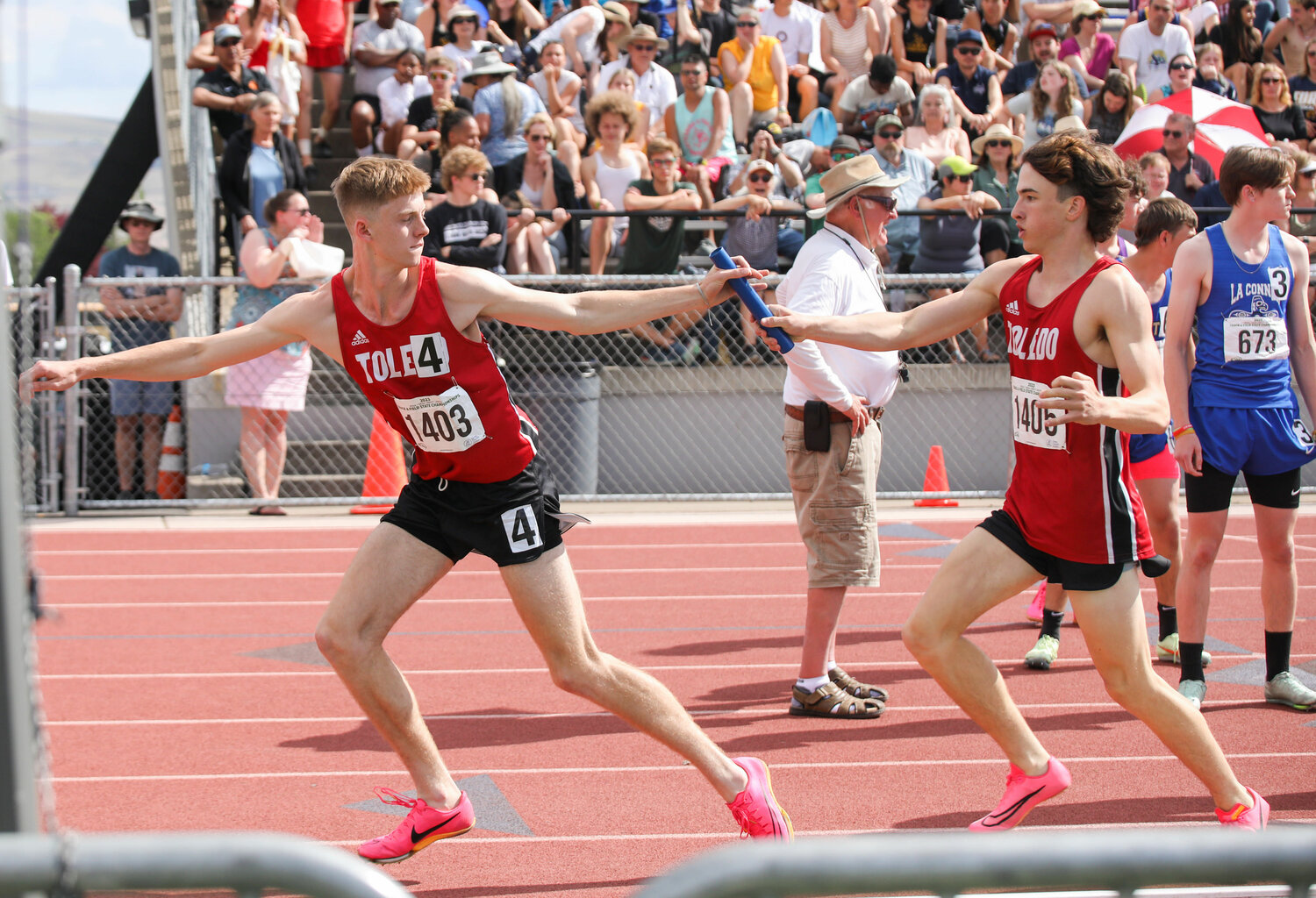 John Rose passes the baton to Connor Olmstead for the final leg of the 2B boys 4x400 relay in the prelims of the state championship meet, May 26 in Yakima.