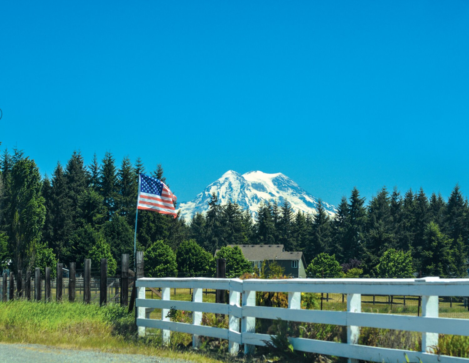Mount Rainier is pictured next to an American Flag on a clear day. The City of Yelm is hosting a Veterans Day concert to celebrate veterans this Saturday at the Yelm Community Center.