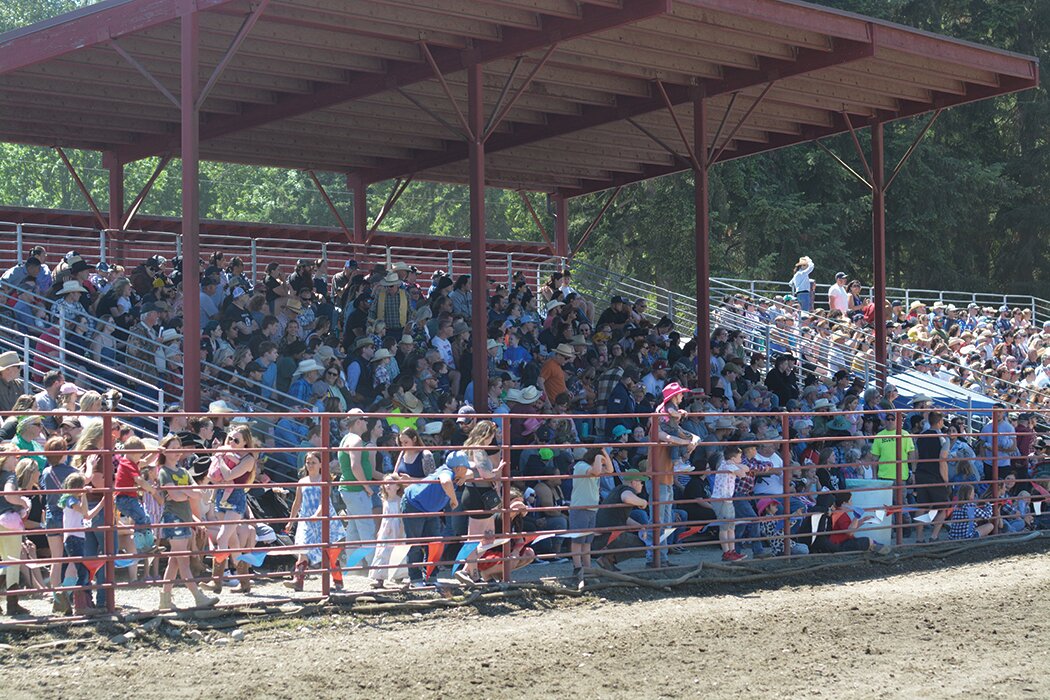 Spectators at the Roy Pioneer Rodeo watch bronc riding on Sunday, June 4.