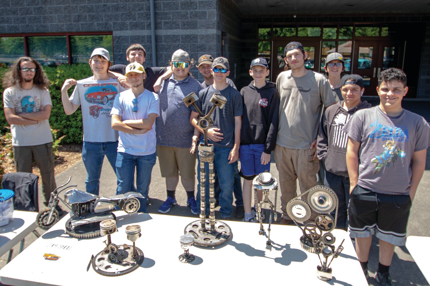 Members of Yelm High School’s SkillsUSA automotive, welding and manufacturing clubs pose in front of the trophies they made for the car show on June 4 at the high school. The car show served as a fundraiser for their clubs.
