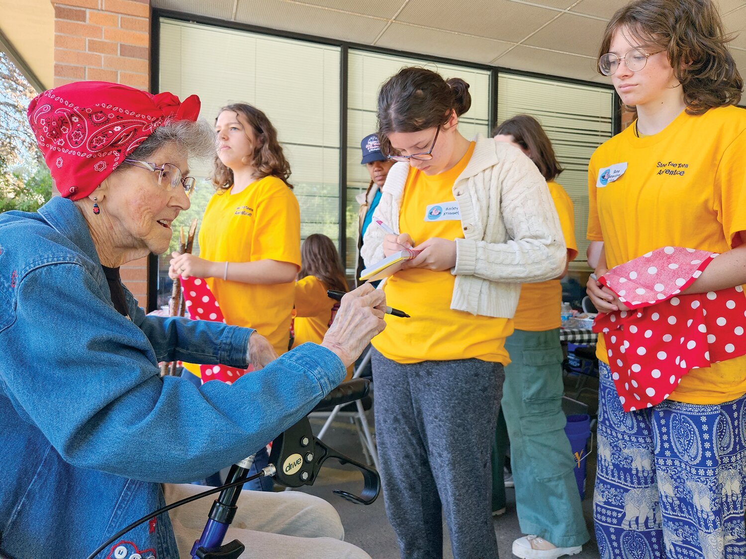 Doris Bier, Lewis County’s last surviving Rosie the Riveter, signs items for girls at the first-ever Steel Toe Teens camp in this photo provided by Julie McDonald.