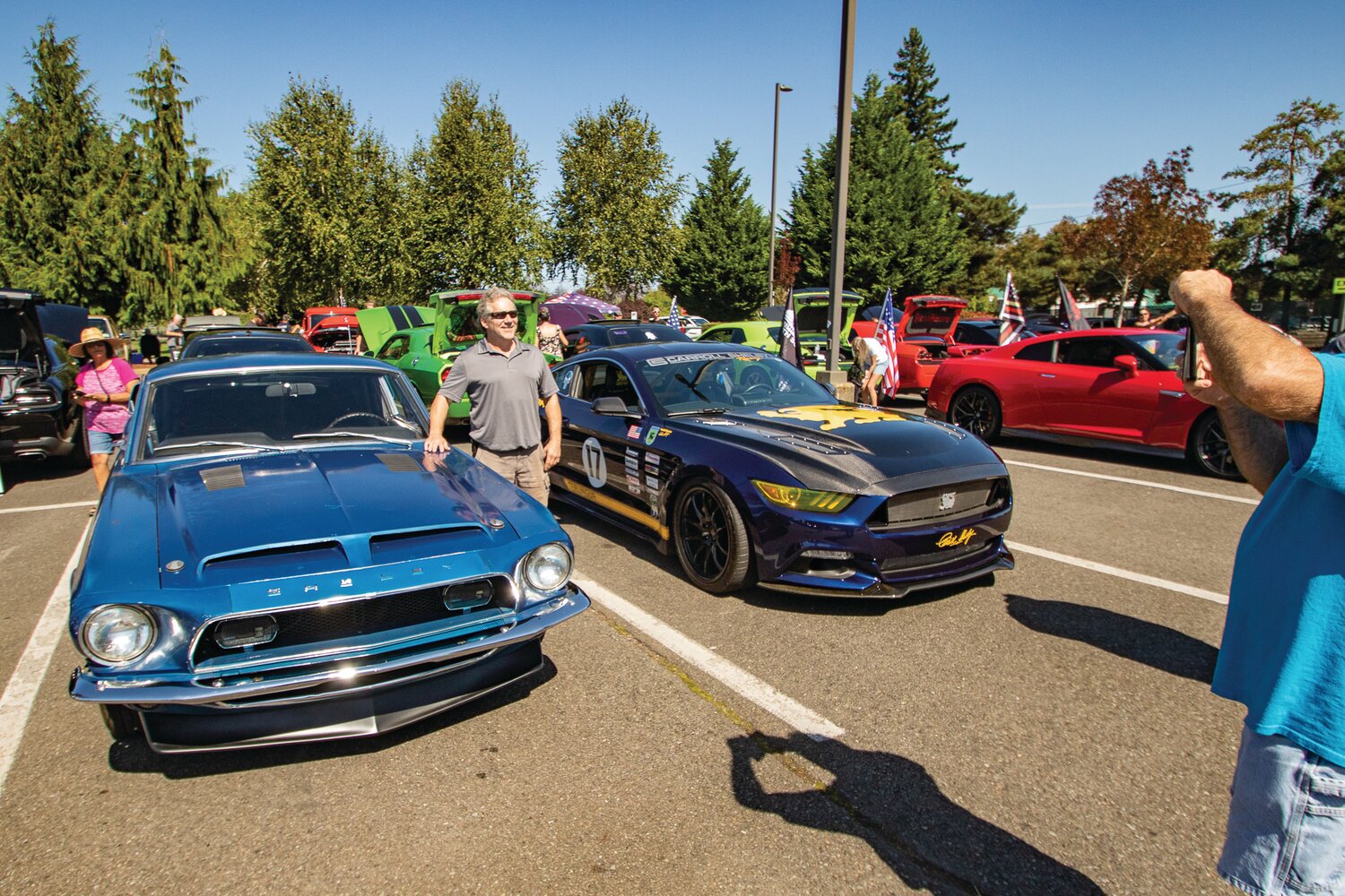 A car show participant stands next to a classic Ford Mustang Shelby GT 350 at the Yelm FFA Alumni Association car show at Yelm High School this past weekend.