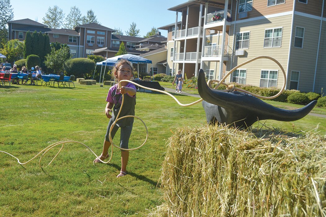 A little girl attempts to rope a steerhead at the Rosemont Round-Up at Prestige Senior Living Rosemont on Sept. 8..