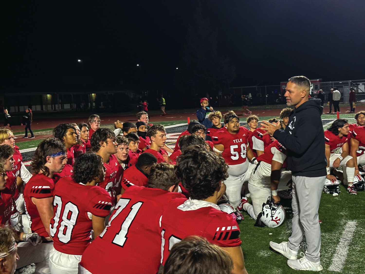Head coach Jason Ronquillo addresses the Tornados after a 59-7 victory over the River Ridge Hawks.