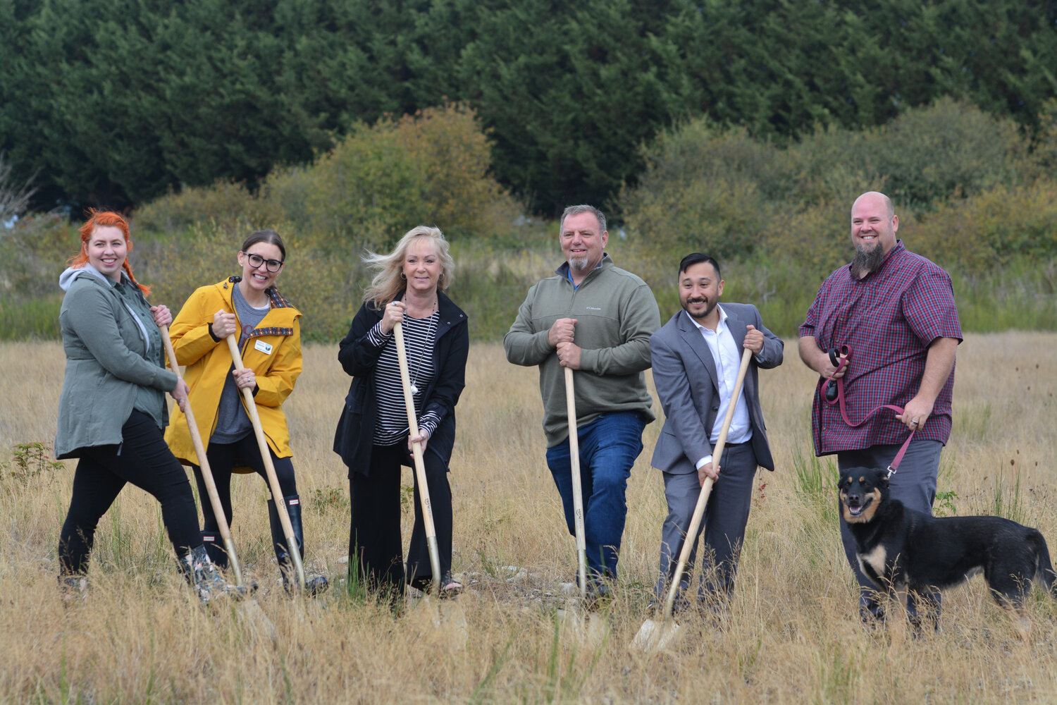 Representatives from the City of Yelm smile as they break ground at Yelm’s future off-leash dog park site.